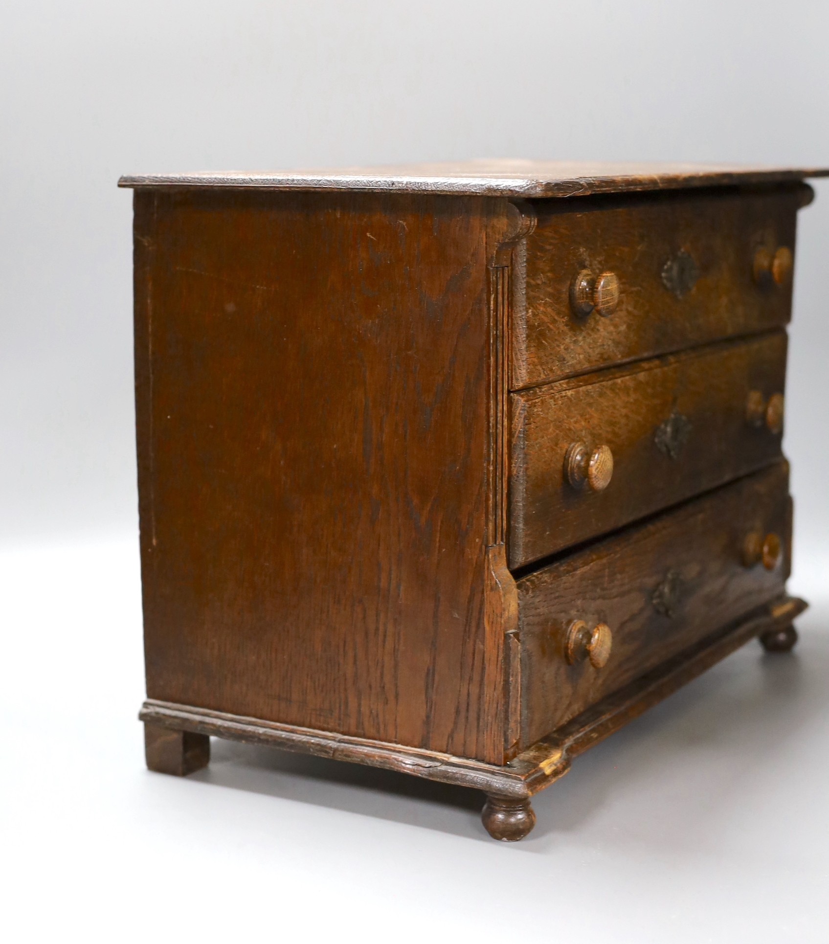 An oak table top chest of three drawers, 39.5cm wide